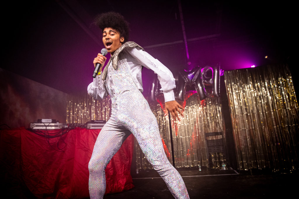 A photograph of a woman performing in drag